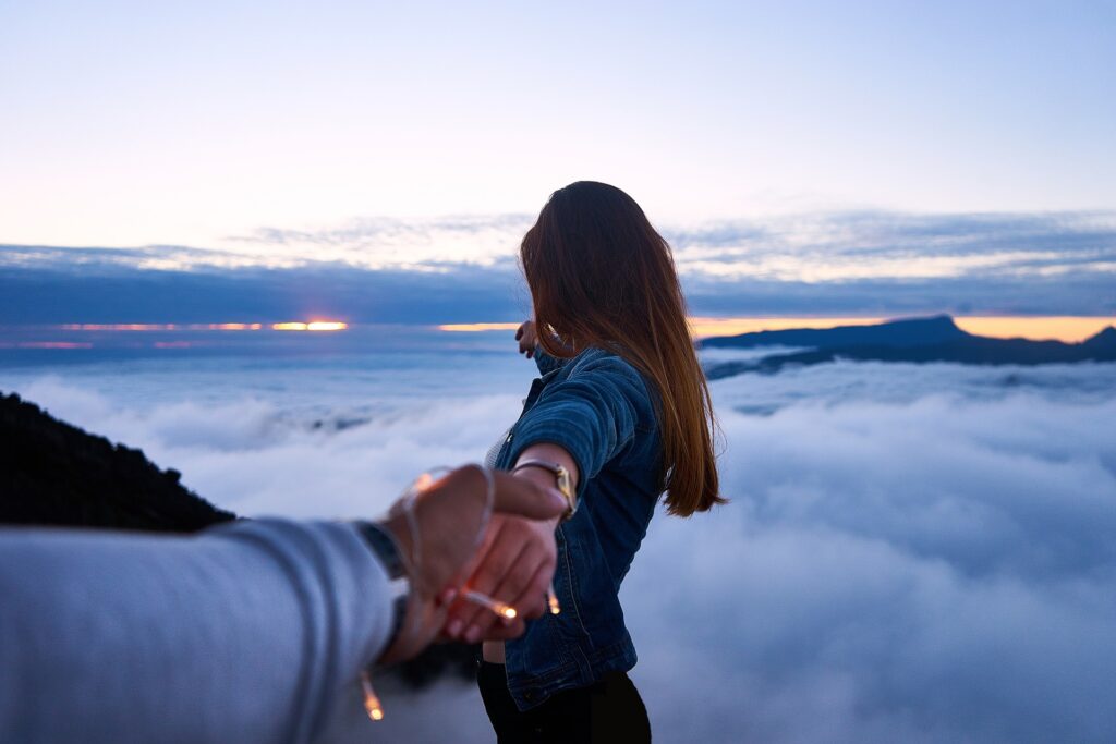 woman above cloud free hand in hand